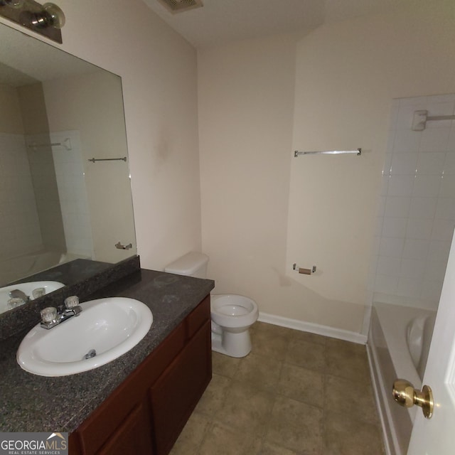 bathroom featuring toilet, vanity, and tile patterned floors