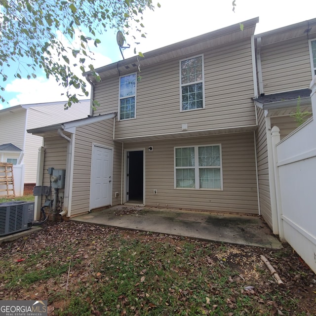 rear view of property featuring central AC and a patio area