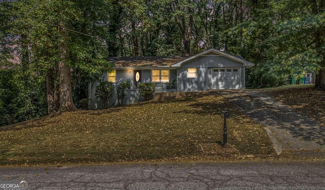 single story home featuring a front yard and a garage