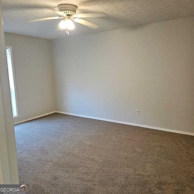 unfurnished room with ceiling fan, a textured ceiling, carpet flooring, and a wealth of natural light