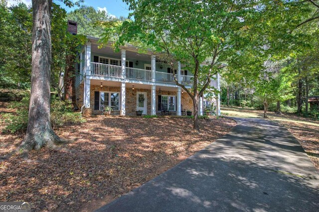 view of front of home with a balcony and a porch