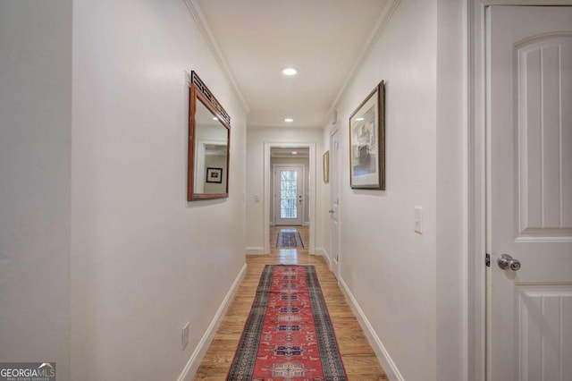 hallway featuring ornamental molding, recessed lighting, wood finished floors, and baseboards