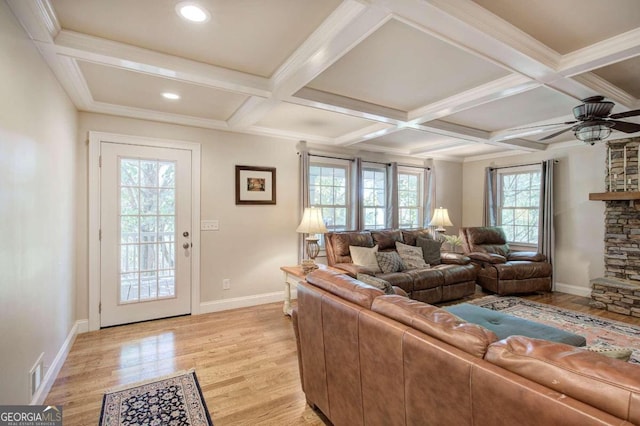 living area with light wood-type flooring, visible vents, coffered ceiling, and beamed ceiling