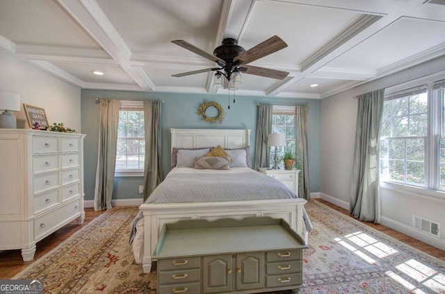 bedroom with baseboards, visible vents, coffered ceiling, wood finished floors, and beam ceiling