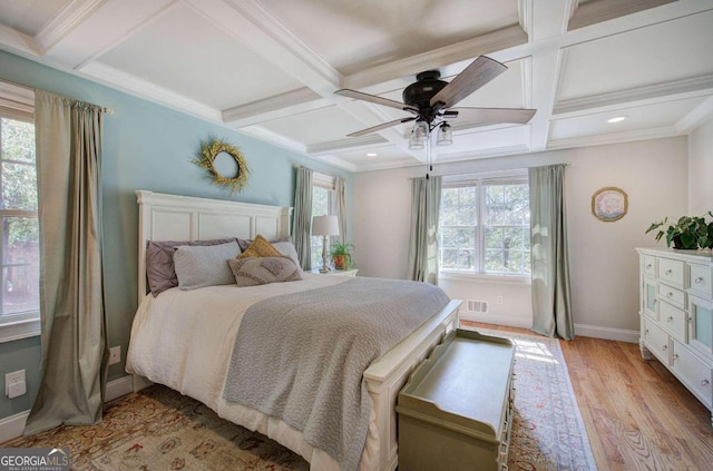 bedroom with coffered ceiling, visible vents, and light wood finished floors