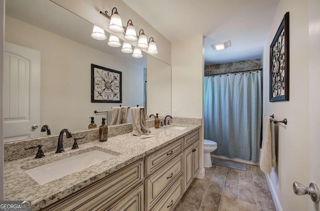 bathroom with wood finished floors, a sink, toilet, and double vanity