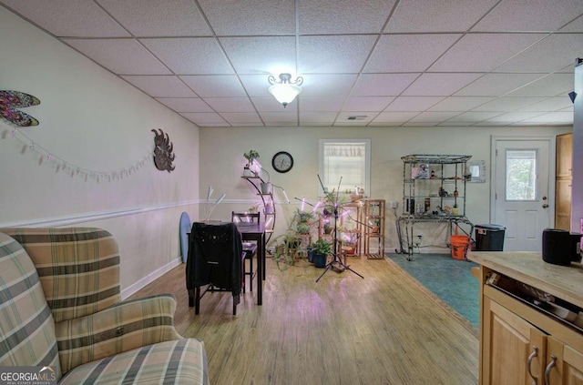 recreation room with light wood-style floors, a drop ceiling, and visible vents