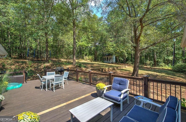 wooden terrace with outdoor dining space