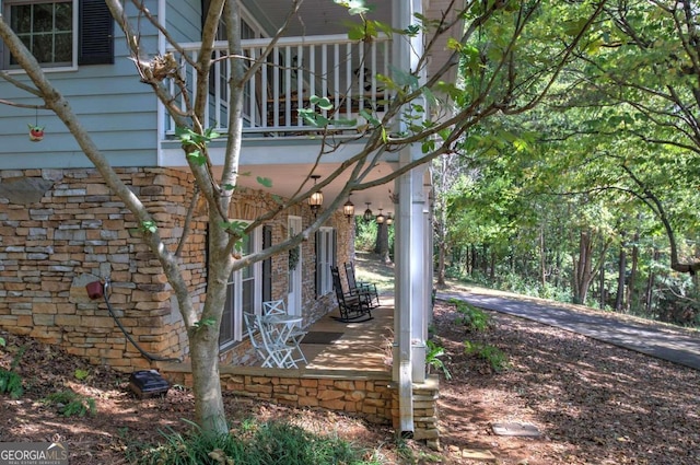 exterior space featuring stone siding