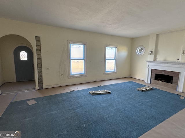 unfurnished living room featuring a textured ceiling