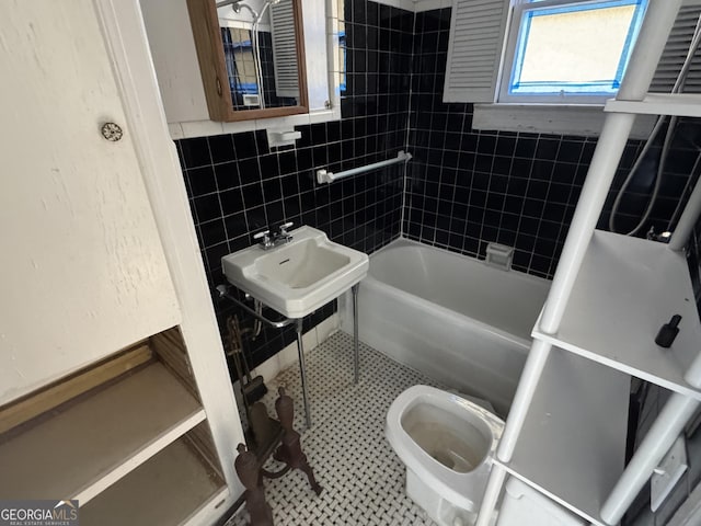 full bathroom with sink, tile patterned flooring, toilet, tile walls, and tiled shower / bath