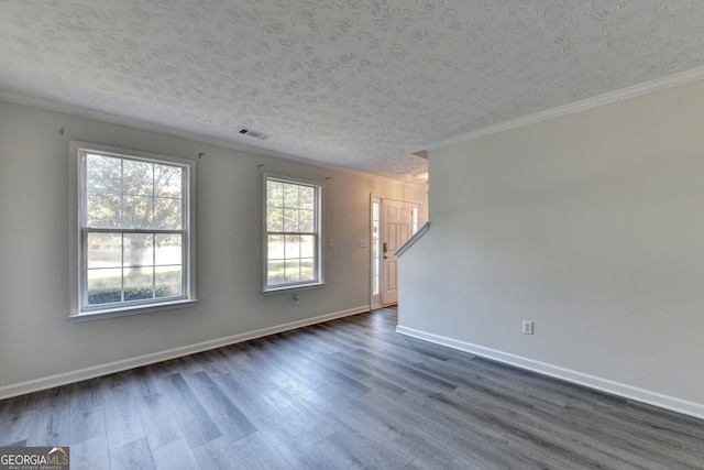 unfurnished room with ornamental molding, dark wood-type flooring, and a textured ceiling