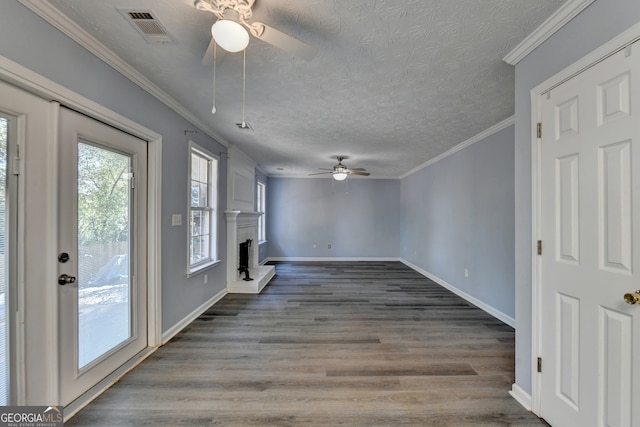 unfurnished living room featuring crown molding, hardwood / wood-style flooring, a textured ceiling, and ceiling fan