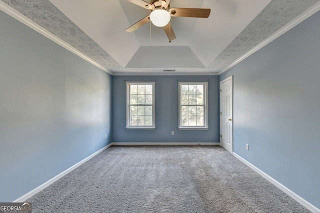 carpeted empty room featuring crown molding, a tray ceiling, and ceiling fan