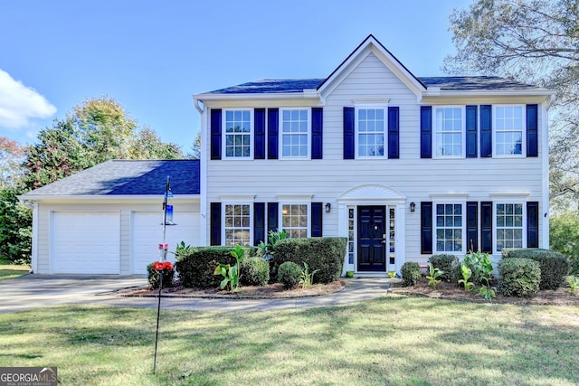 colonial house with a garage and a front lawn