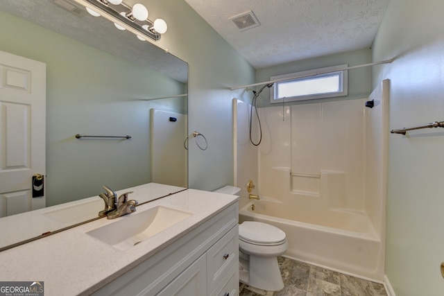 full bathroom with vanity, washtub / shower combination, a textured ceiling, and toilet