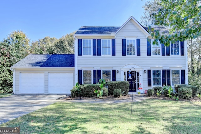 colonial-style house with a front yard and a garage