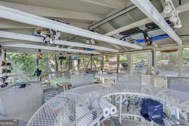 sunroom / solarium featuring vaulted ceiling