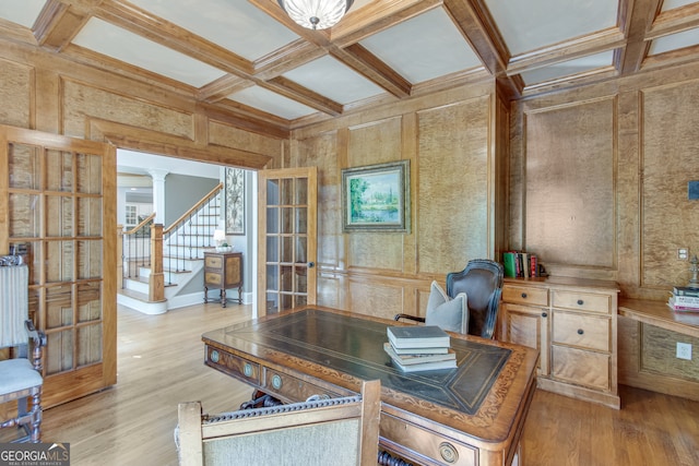 office space with decorative columns, beam ceiling, light wood-type flooring, and coffered ceiling