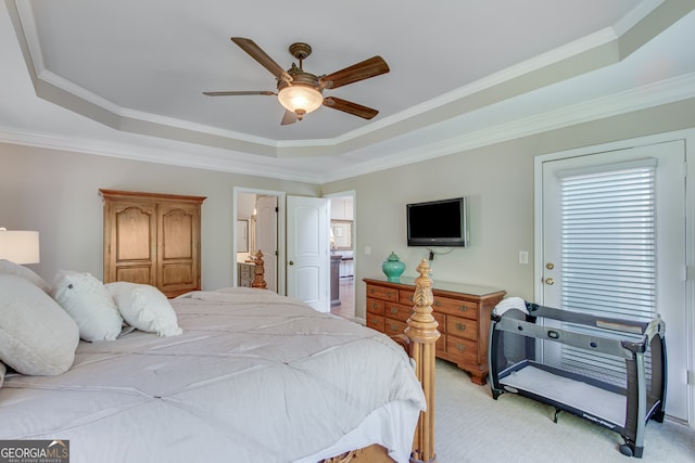 carpeted bedroom with a tray ceiling, ceiling fan, and crown molding