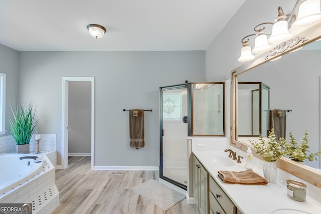 bathroom with independent shower and bath, vanity, and wood-type flooring