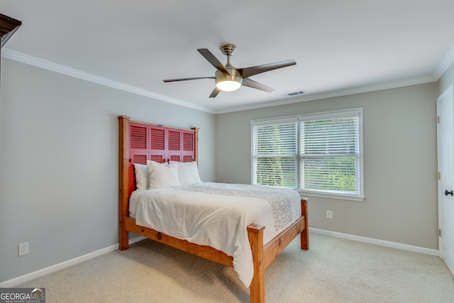 carpeted bedroom featuring ceiling fan and crown molding