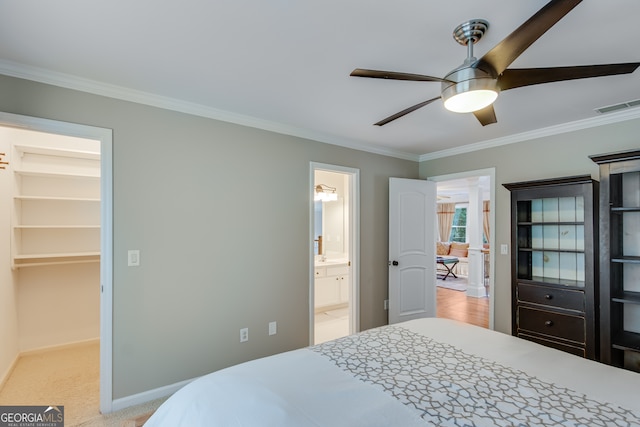 bedroom with ceiling fan, crown molding, light carpet, and a spacious closet