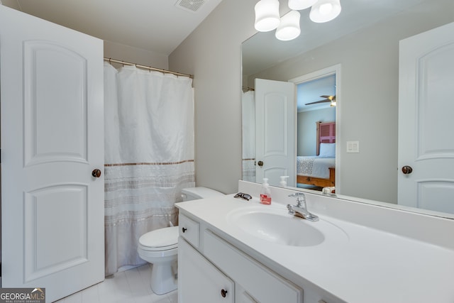 bathroom with toilet, vanity, tile patterned flooring, and ceiling fan