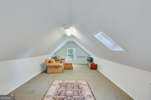 additional living space with vaulted ceiling with skylight and light carpet