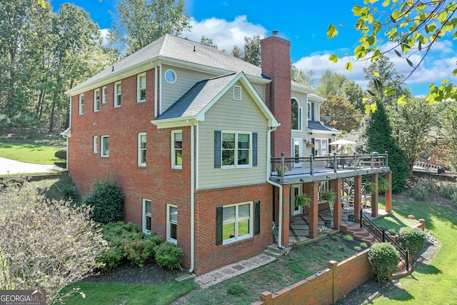 view of side of home with a wooden deck