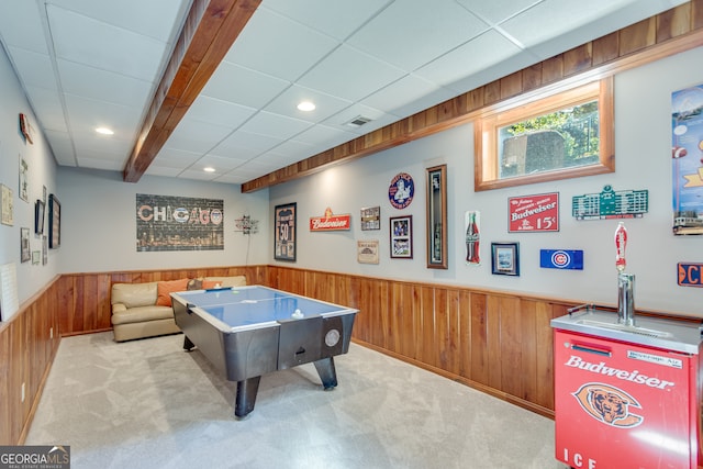 playroom featuring light colored carpet and wooden walls