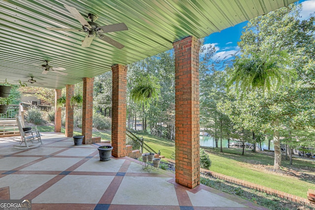 view of patio / terrace with a water view and ceiling fan