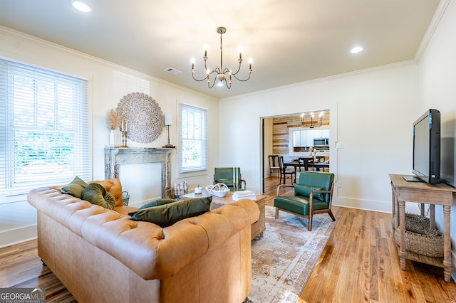 living room with a multi sided fireplace, an inviting chandelier, light wood-type flooring, and ornamental molding