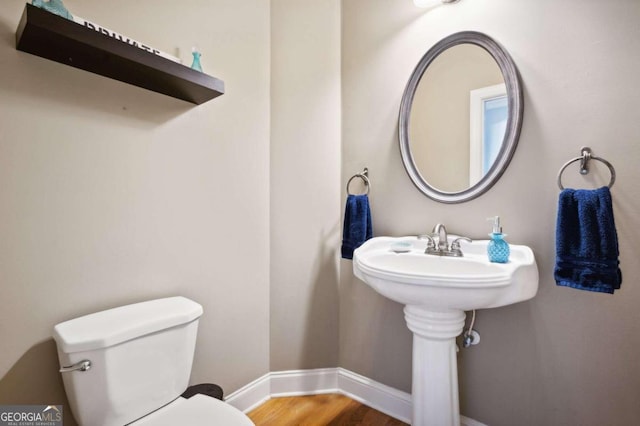 bathroom with toilet and hardwood / wood-style flooring