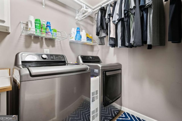 laundry area featuring cabinets and washing machine and dryer