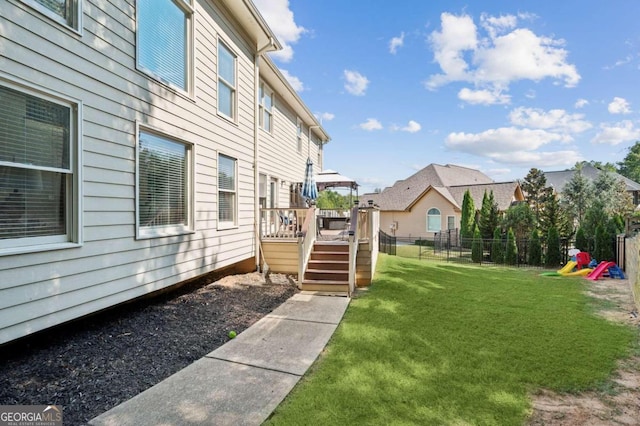 view of yard with a playground and a deck