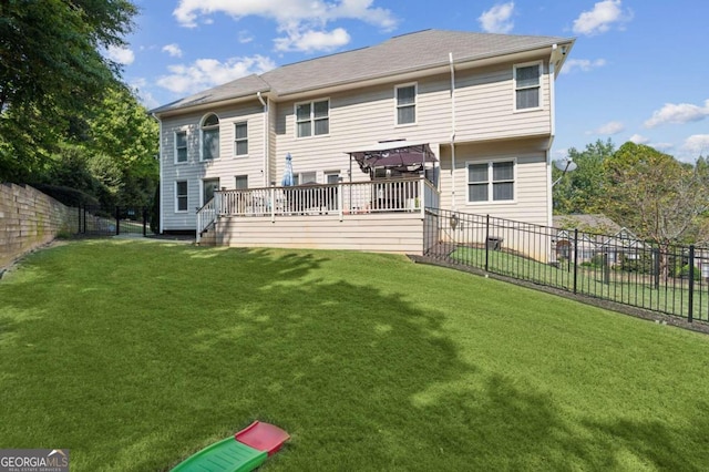 back of property featuring a lawn and a wooden deck