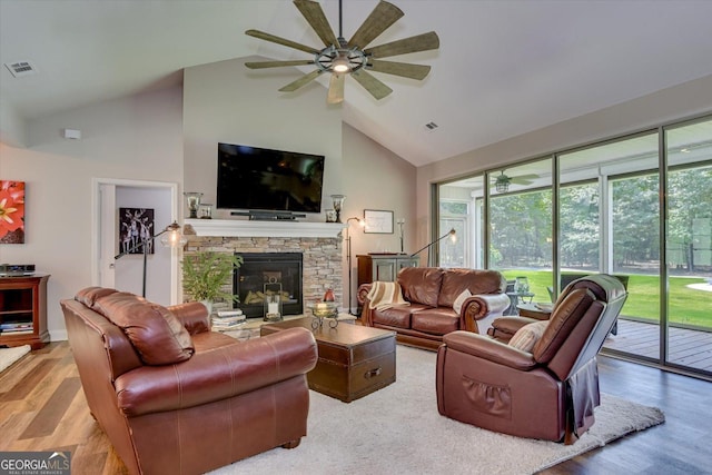 1370 Deerwood Cir, Stapleton, GA 30823 - living room featuring high vaulted ceiling, a ceiling fan, wood finished floors, and a fireplace