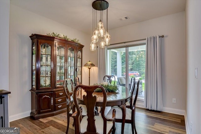 1370 Deerwood Cir, Stapleton, GA 30823 - dining room with dark wood-style floors and a chandelier
