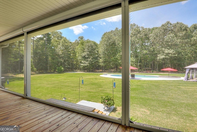 1370 Deerwood Cir, Stapleton, GA 30823 - unfurnished sunroom featuring view of scattered trees and healthy amount of natural light