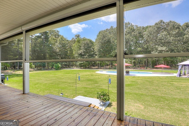 1370 Deerwood Cir, Stapleton, GA 30823 - wooden terrace featuring an outdoor pool, a lawn, and view of scattered trees