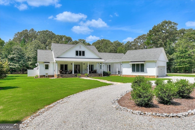 1370 Deerwood Cir, Stapleton, GA 30823 - modern farmhouse with an attached garage, gravel driveway, roof with shingles, covered porch, and a front lawn