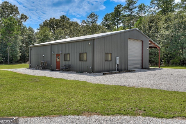 1370 Deerwood Cir, Stapleton, GA 30823 - detached garage with gravel driveway and view of wooded area