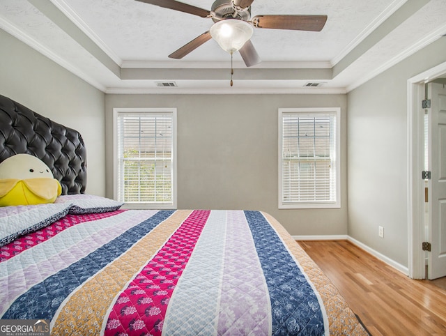 bedroom with ornamental molding, ceiling fan, and multiple windows