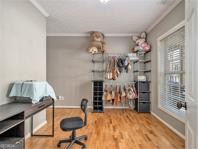 home office featuring light wood-type flooring and ornamental molding