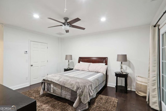 bedroom featuring ornamental molding, dark hardwood / wood-style flooring, ceiling fan, and a closet