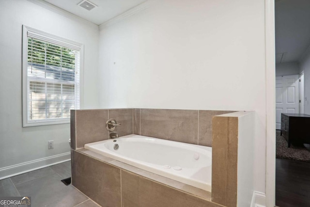 bathroom featuring ornamental molding, tile patterned flooring, and tiled bath