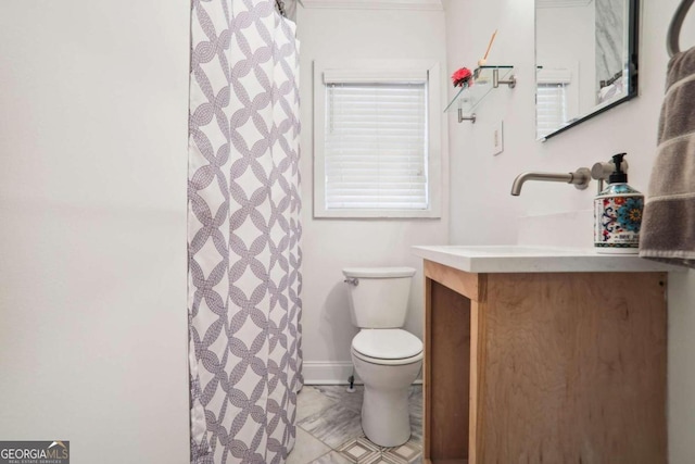 bathroom featuring walk in shower, vanity, and toilet