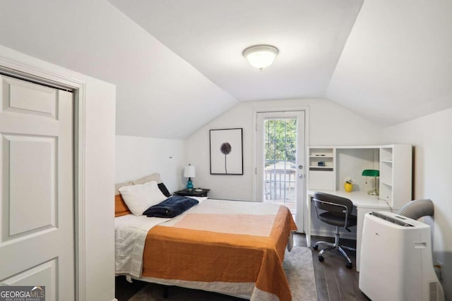 bedroom with vaulted ceiling, access to outside, and dark hardwood / wood-style flooring