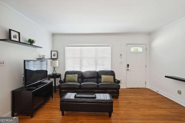 living room with hardwood / wood-style floors and crown molding